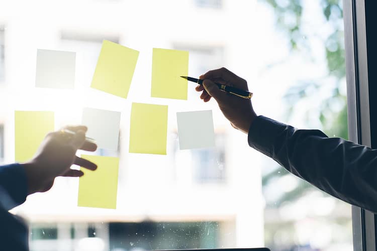 business-people-meeting-at-office-and-use-post-it-notes-to-share-idea-brainstorming-concept-sticky-note-on-glass-wall-free-photo